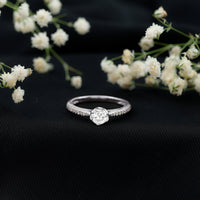 Rosec Jewels Lotus Basket Set engagement ring with cubic zirconia and side stones, featuring a detailed floral design and sparkling accents.
