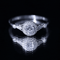 Antique-inspired zircon halo engagement ring from Rosec Jewels featuring a central stone surrounded by smaller zircon accents.