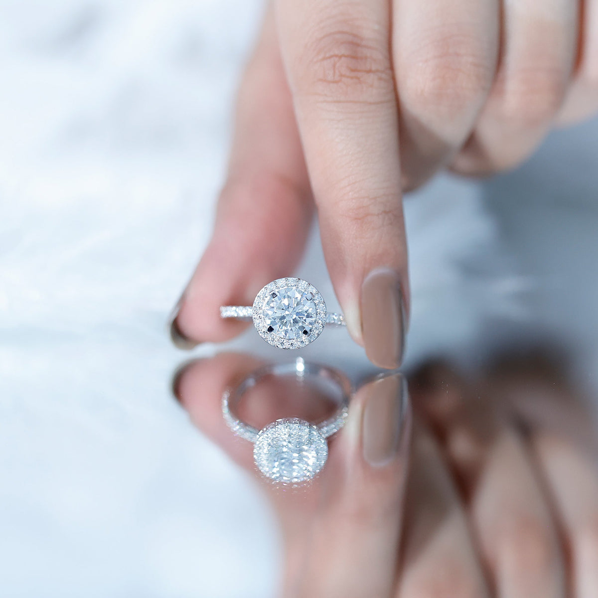 Elegant Rosec Jewels cubic zirconia floating halo engagement ring with a classic design and sparkling stones.