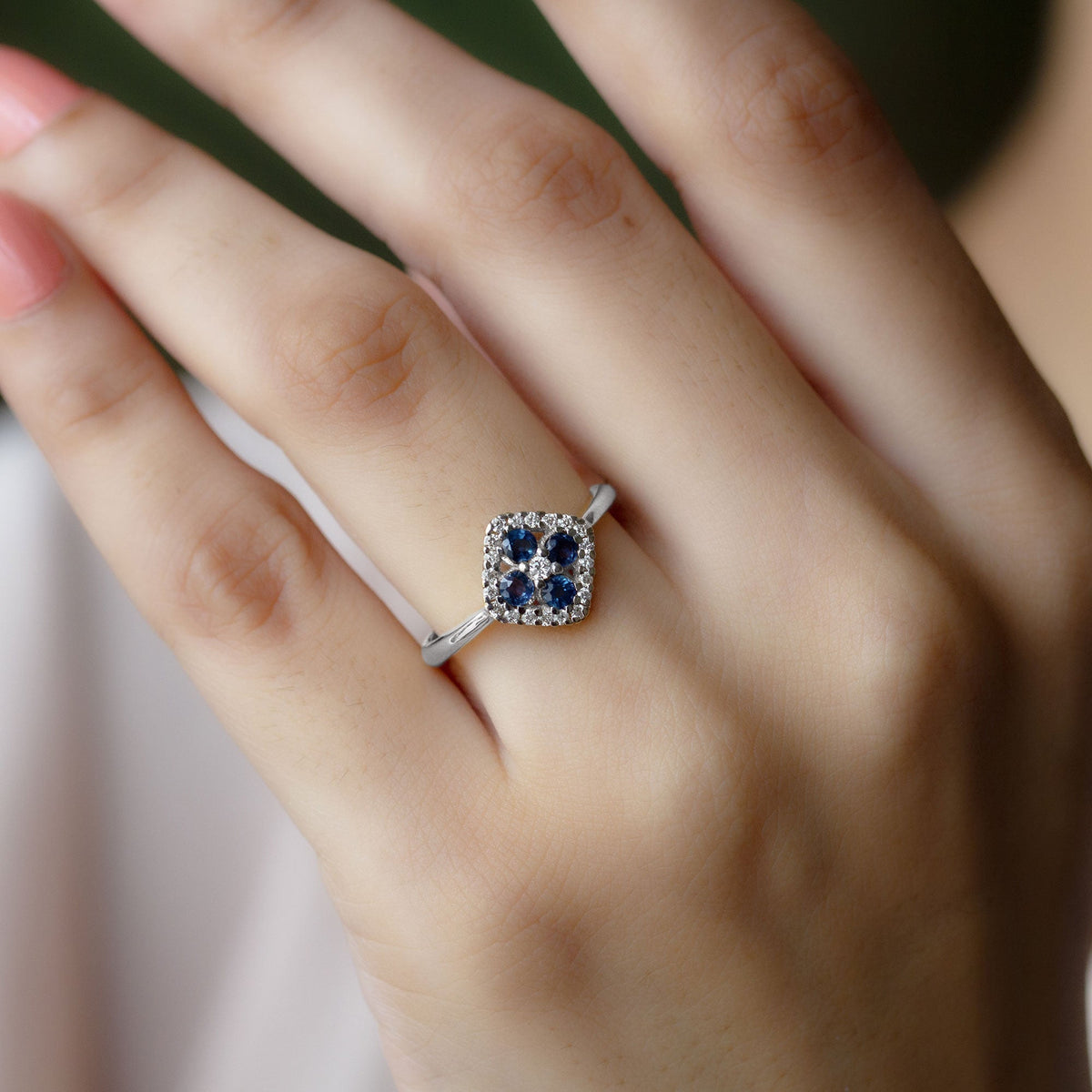 Blue sapphire cluster ring with diamond accents, featuring a 1/2 carat sapphire set in a elegant Rosec Jewels ring design.