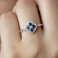 Rosec Jewels 1/2 CT blue sapphire cluster ring with diamond accents showcasing a sparkling blue gemstone and elegant design.