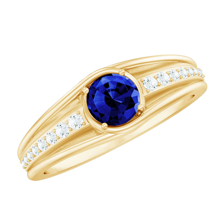 Created blue sapphire and diamond engagement ring by Rosec Jewels featuring a classic design with a central sapphire and surrounding diamonds.