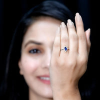 Marquise cut lab-grown blue sapphire engagement ring with diamond halo, featuring a Rosec Jewels design and intricate band details.
