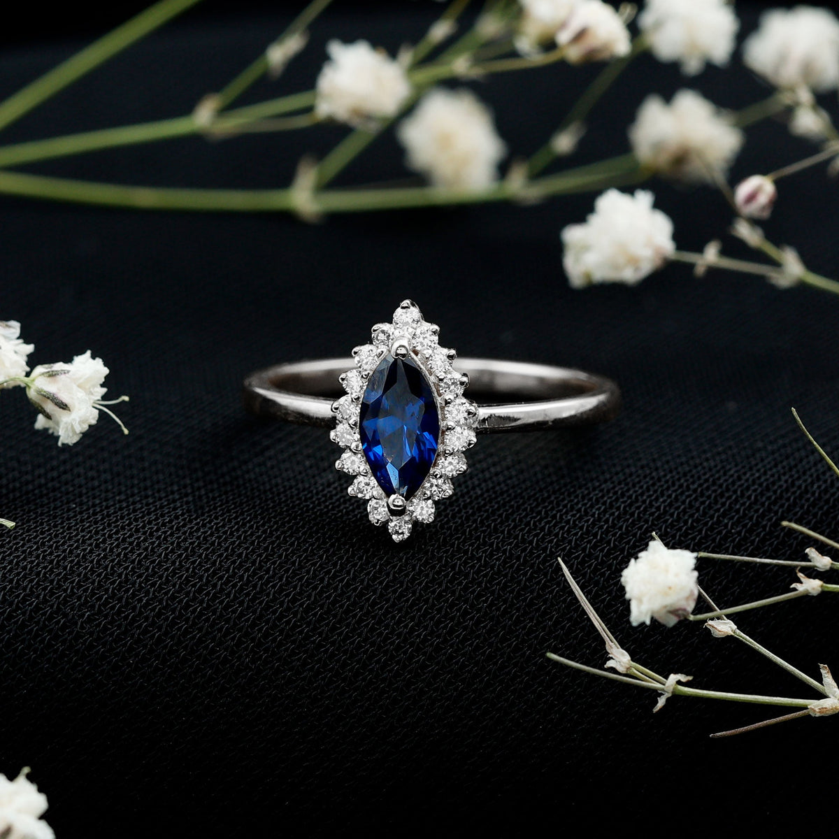 Marquise cut lab-grown blue sapphire engagement ring with diamond halo, featuring Rosec Jewels' elegant ring design.