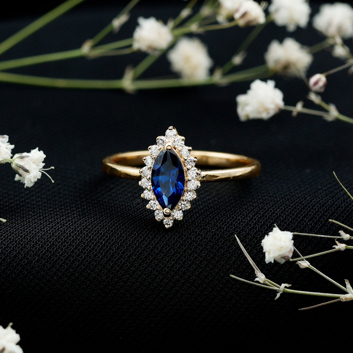 Marquise cut lab-grown blue sapphire and diamond halo engagement ring by Rosec Jewels, showcasing intricate design and sparkling gemstones.