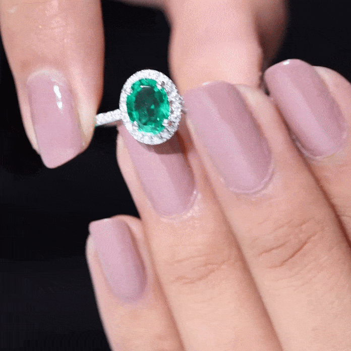 Yellow gold oval lab-grown emerald engagement ring with diamond halo by Rosec Jewels, showcasing intricate design and sparkling accents.