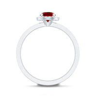 Lab-created ruby and diamond halo engagement ring from Rosec Jewels featuring a 0.6 carat center stone and intricate band details.