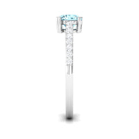 Rosec Jewels aquamarine solitaire engagement ring with diamond, featuring a sleek design and a central aquamarine gemstone.