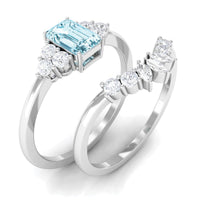 Emerald cut aquamarine wedding ring set with diamonds from Rosec Jewels, featuring two elegant rings with blue gemstone and diamond accents.
