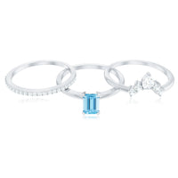 Set of three Rosec Jewels emerald cut aquamarine solitaire rings with diamond accents, showcasing elegant gemstone and metal design.