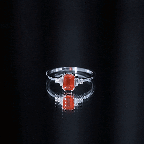 Emerald cut fire opal engagement ring with diamonds from Rosec Jewels, showcasing the ring's elegant design and sparkling gemstones.