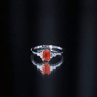 Emerald cut fire opal engagement ring with diamonds from Rosec Jewels, showcasing the ring's elegant design and sparkling gemstones.