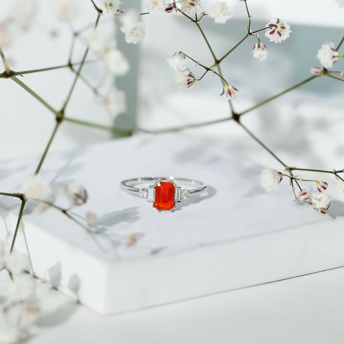 Emerald cut fire opal engagement ring with diamond accents by Rosec Jewels, showcasing a stunning 1-carat gemstone and intricate band.