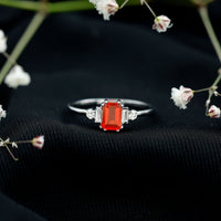 Emerald cut fire opal engagement ring with diamonds from Rosec Jewels, showcasing a 1-carat fiery gemstone and sparkling accents.