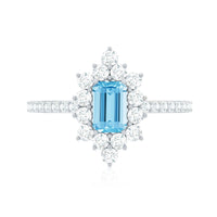 Vintage aquamarine and diamond halo engagement ring by Rosec Jewels featuring an intricate design and sparkling gemstones.