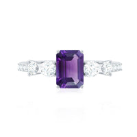 Real 1.4 carat emerald cut amethyst engagement ring with moissanite, featuring a silver band and intricate detailing.
