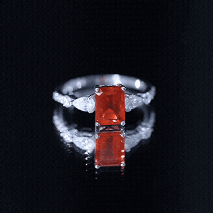 Emerald cut 1 carat fire opal engagement ring with diamond side stones from Rosec Jewels, showcasing the sparkling gemstone and elegant band.