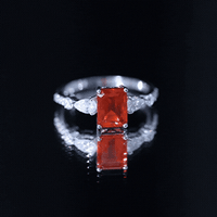 Emerald cut 1 carat fire opal engagement ring with diamond side stones from Rosec Jewels, showcasing the sparkling gemstone and elegant band.