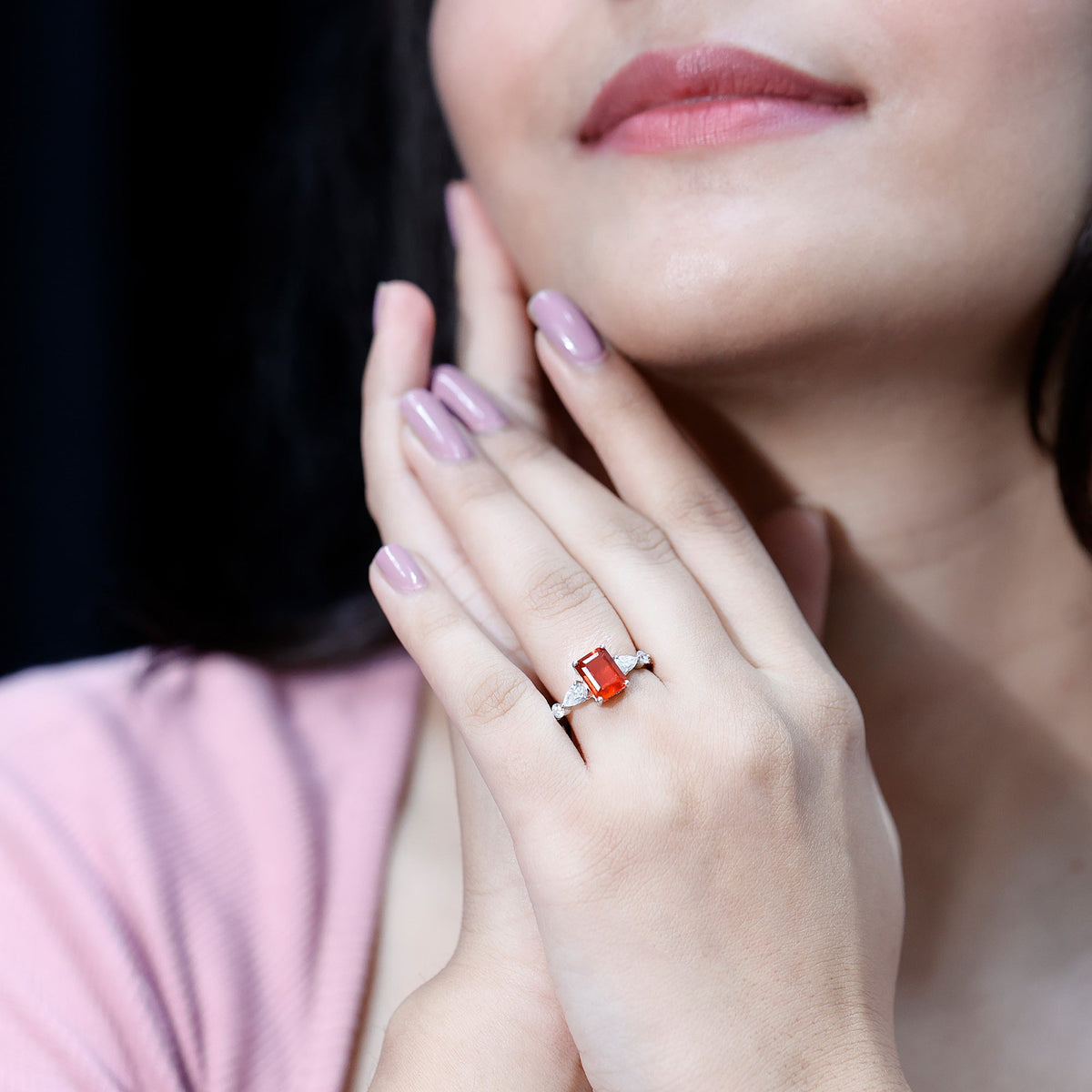 Emerald cut 1 carat fire opal engagement ring with diamond side stones, featuring a Rosec Jewels design and a sleek band.