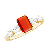 Emerald cut 1 carat fire opal engagement ring with diamond side stones, showcasing a rose gold band and intricate detailing.