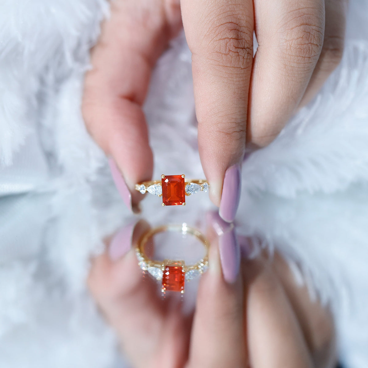 Emerald cut 1-carat fire opal engagement ring with diamond side stones from Rosec Jewels, showcasing a vibrant orange gemstone.