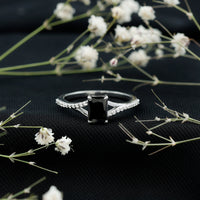 Certified 1.6 carat lab-grown black diamond engagement ring with emerald cut and white diamond split shank by Rosec Jewels.
