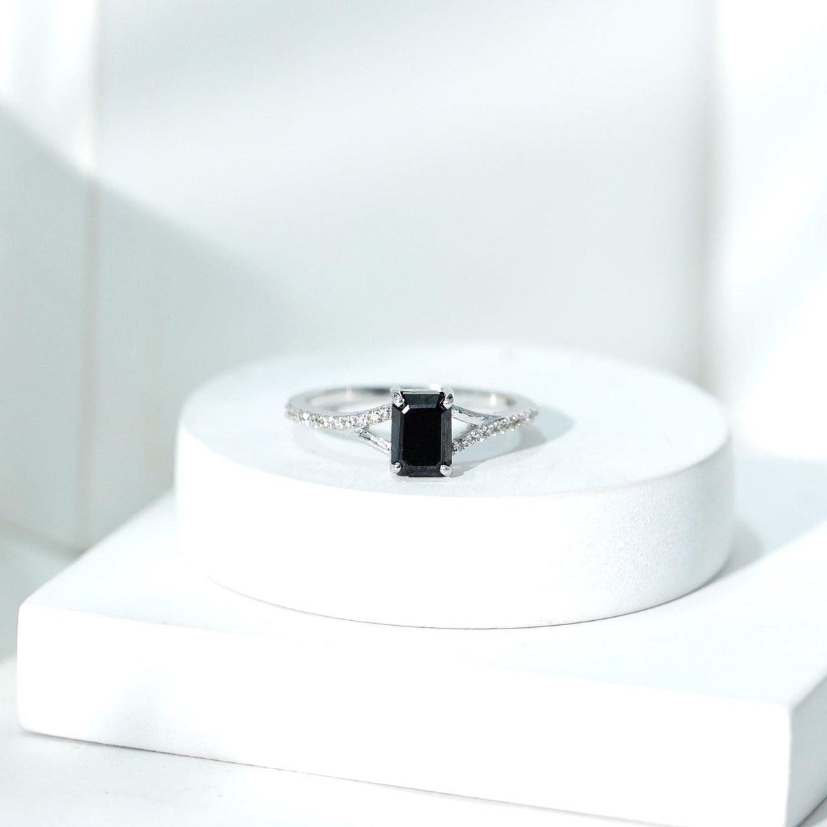 Lab grown black diamond engagement ring with white diamonds, emerald cut, split shank design from Rosec Jewels.