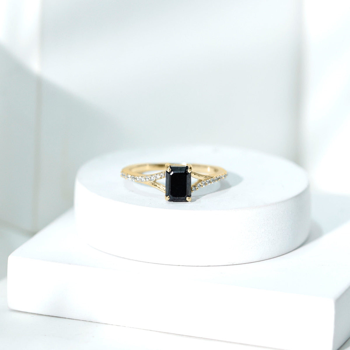 Lab grown black diamond emerald cut engagement ring with white diamond split shank by Rosec Jewels, showcasing sparkling stones and elegant design.