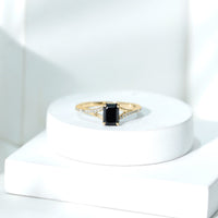 Lab grown black diamond emerald cut engagement ring with white diamond split shank by Rosec Jewels, showcasing sparkling stones and elegant design.