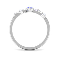 Marquise Tanzanite solitaire ring with scatter diamonds from Rosec Jewels, showcasing a minimalist design and sparkling gemstone.