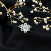 Rosec Jewels 0.85 CT moonstone and diamond floral halo engagement ring with intricate design and sparkling gemstones.