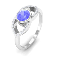Bezel set tanzanite solitaire ring with split shank design and diamond accents by Rosec Jewels.