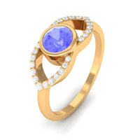 Bezel set tanzanite solitaire split shank ring with diamond accents by Rosec Jewels, showcasing a stunning blue gemstone and elegant design.