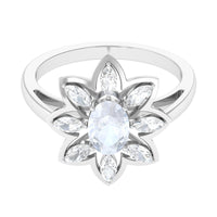 Oval cut moonstone and diamond flower cocktail ring by Rosec Jewels, showcasing a sparkling gemstone and intricate floral design.