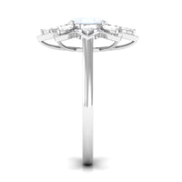 Oval cut moonstone and diamond flower cocktail ring by Rosec Jewels, featuring a detailed gold band with floral design.