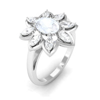 Oval cut moonstone and diamond flower cocktail ring by Rosec Jewels, featuring a sparkling gemstone design with delicate floral accents.