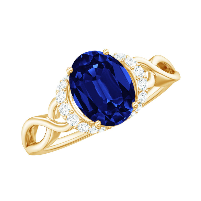 Lab grown 1.5 carat blue sapphire and diamond oval engagement ring with crossover shank by Rosec Jewels.