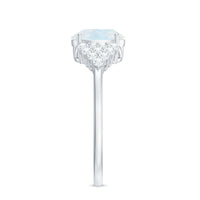 Oval cut moonstone solitaire ring with diamond accent, featuring a silver band and elegant design by Rosec Jewels.