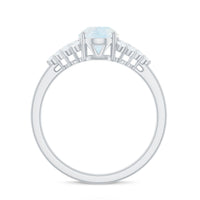 Oval cut moonstone solitaire ring with diamond accent from Rosec Jewels, showcasing the elegant gemstone setting.