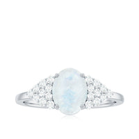 Oval cut moonstone solitaire ring with diamond accent by Rosec Jewels, featuring a silver band and elegant design.
