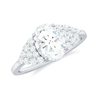 Oval moissanite engagement ring with cluster side stones, 6x8 mm, set in a Rosec Jewels ring with intricate detailing.