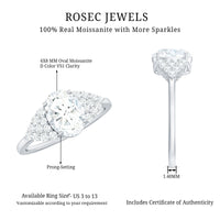 Oval moissanite engagement ring with 6x8 mm center stone and cluster side stones, Rosec Jewels ring in a close-up view.