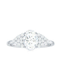 Oval moissanite engagement ring with 6x8mm center stone and cluster side stones, crafted by Rosec Jewels.