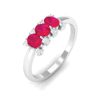 Oval ruby three stone promise ring with diamond accents from Rosec Jewels, showcasing the elegant design and vibrant gemstones.