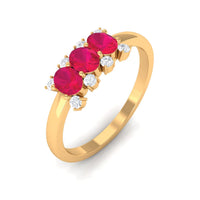 Oval ruby three-stone promise ring with diamond accents from Rosec Jewels, showing the elegant design and sparkling gemstones.