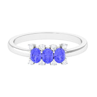 Oval cut Tanzanite three-stone ring with diamonds from Rosec Jewels, showcasing the elegant gemstone and sparkling accents.