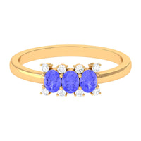 Oval cut tanzanite three stone ring with diamond accents, featuring Rosec Jewels' elegant design and sparkling gemstone details.