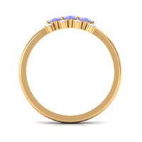 Oval cut Tanzanite three stone ring with diamonds by Rosec Jewels, showcasing the elegant gemstone and sparkling diamond accents.