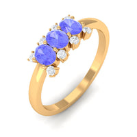 Oval cut tanzanite three stone ring with diamond accents, crafted by Rosec Jewels, showcasing elegant gemstone and diamond details.