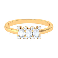 Oval cut moonstone three-stone ring with diamond accents from Rosec Jewels, showcasing the elegant gemstone arrangement.